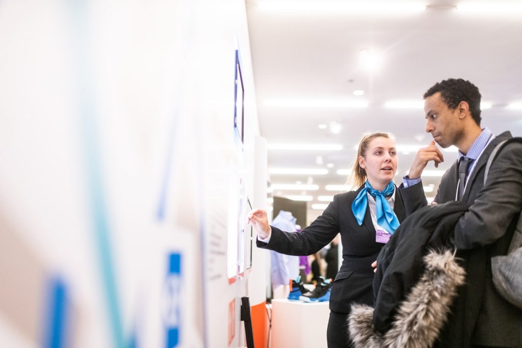 career advice man and woman talking near the wall