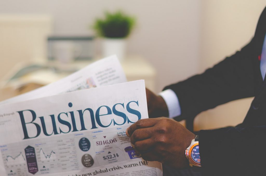 accountancy courses person wearing suit reading business newspaper