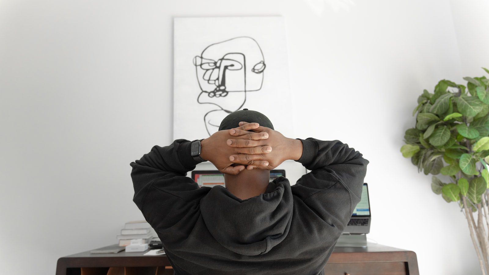 man in gray hoodie sitting on chair freelancer