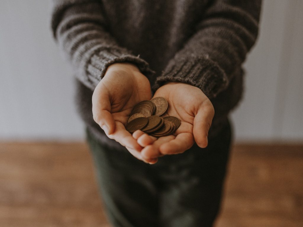 small business copper-colored coins on in person's hands